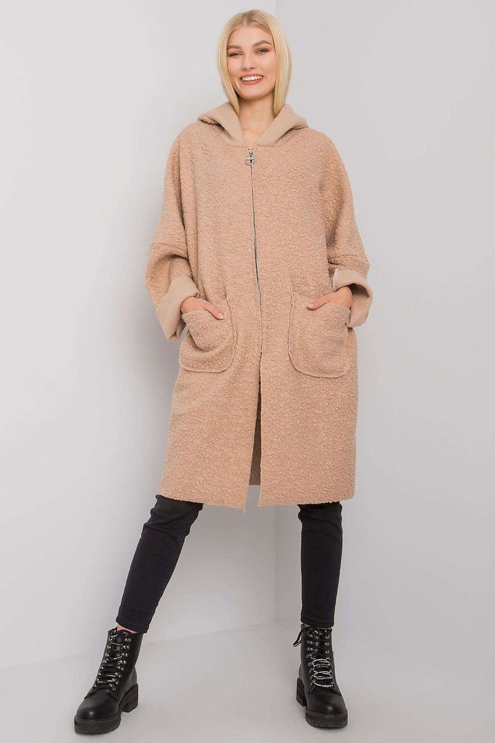 A sleek beige women's coat featuring a zipper closure, a practical hood, and spacious pockets. Designed for comfort and style, it pairs well with various outfits.
