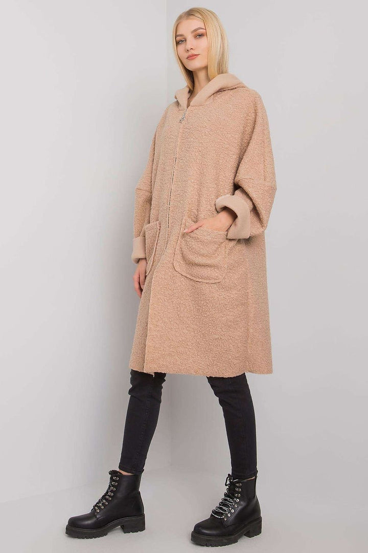 A sleek beige women's coat featuring a zipper closure, a practical hood, and spacious pockets. Designed for comfort and style, it pairs well with various outfits.
