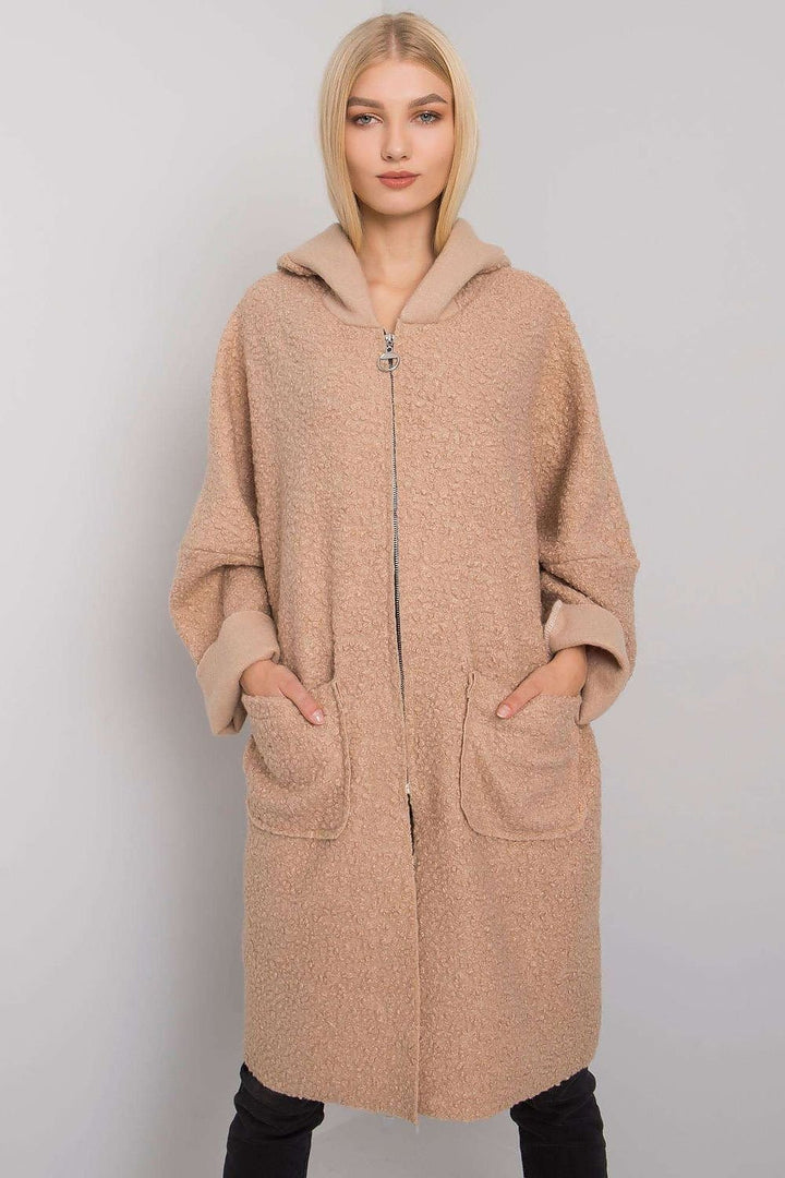 A sleek beige women's coat featuring a zipper closure, a practical hood, and spacious pockets. Designed for comfort and style, it pairs well with various outfits.






