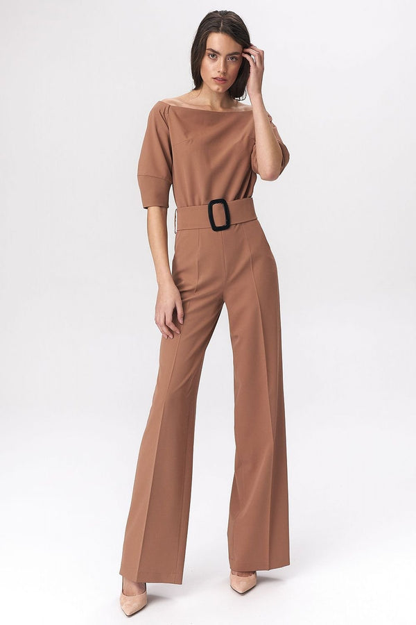 Elegant black women's suit featuring a cold-shoulder design that gracefully highlights the shoulders. A wide belt with a bold buckle cinches the waist for a flattering silhouette. Crafted from a soft viscose-blend fabric for superior comfort, this suit offers a chic and modern twist on traditional office wear.