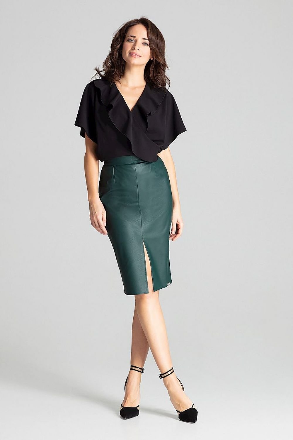 Black eco-leather midi pencil skirt. Fastened at the front with a decorative clasp and at the back with a covered zip. No pockets and no lining. A delicate slit in the middle at the front.
