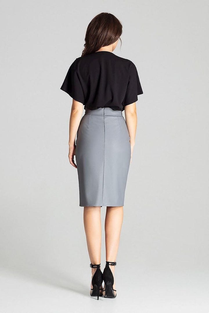 Black eco-leather midi pencil skirt. Fastened at the front with a decorative clasp and at the back with a covered zip. No pockets and no lining. A delicate slit in the middle at the front.
