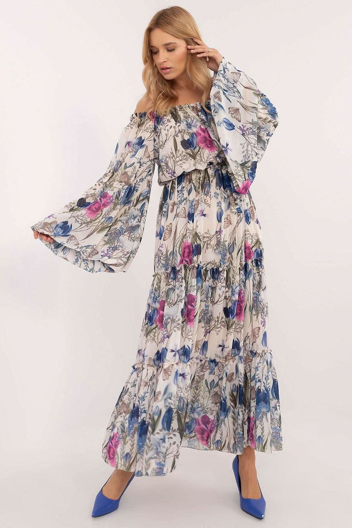 Elegant boho-style maxi dress with a flared cut, Spanish neckline, and delicate floral pattern. Featuring long wide sleeves for comfort and warmth, a ruffled bottom, and an attached belt to accentuate the waist. This dress combines romantic flair with casual elegance, perfect for any occasion.




