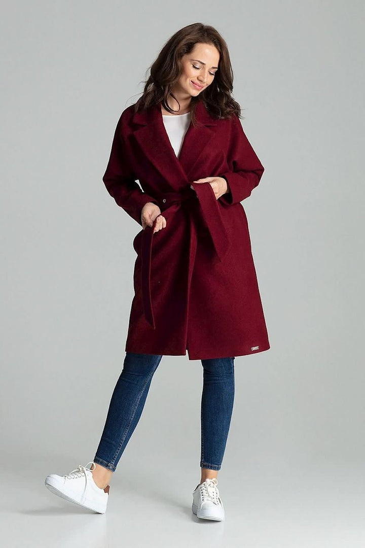 A refined black coat with wide lapels, designed to be worn unbuttoned and tied at the waist with a belt featuring metal eyelets. The coat includes side seam pockets and a matching color lining, offering a sleek and timeless look.







