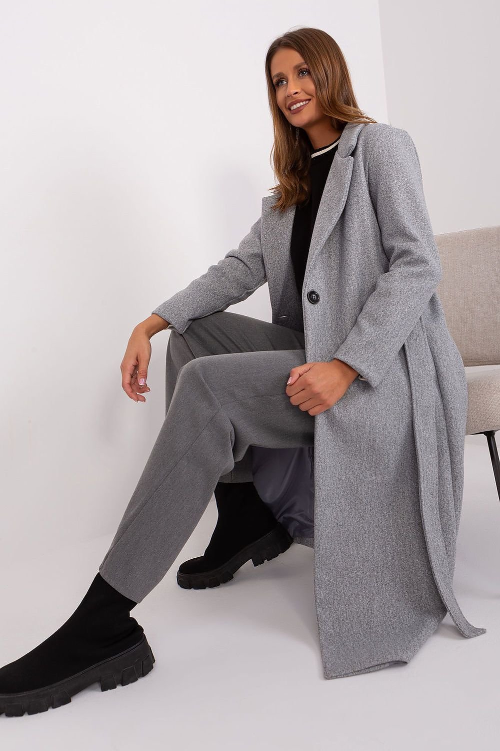 A versatile women's long transitional coat made from durable polyester, featuring a button closure, tie belt, and practical slip pockets. With a classic plain pattern, this uninsulated coat is perfect for autumn and spring, offering both style and comfort for casual, work, or formal occasions.






