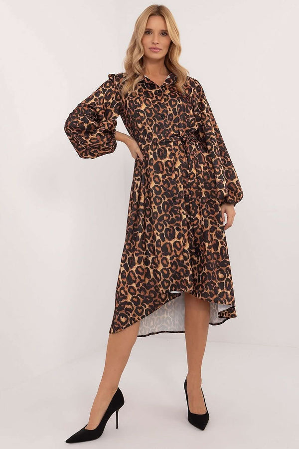 A stylish midi-length shirt dress featuring an asymmetrical cut, smooth pattern, collared neckline, and button closure. Designed with puff cuffed sleeves, a tie belt to define the waist, and practical slip pockets. Made from a soft viscose-polyester blend for comfort and elegance, perfect for work or formal occasions.






