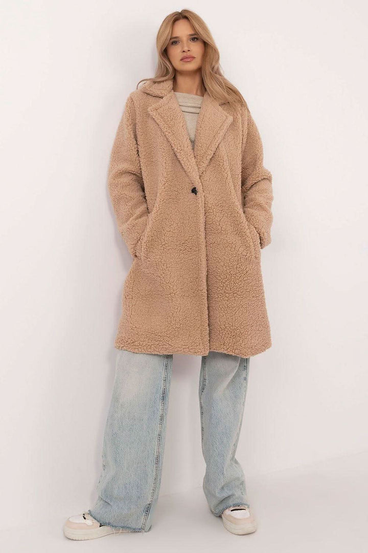 Stylish knee-length winter coat made from a polyester-viscose blend, perfect for everyday wear and work during colder months. Featuring a simple cut, long sleeves, button closure, slip pockets, and a comfortable lining, this coat offers warmth, comfort, and versatility in a classic design.