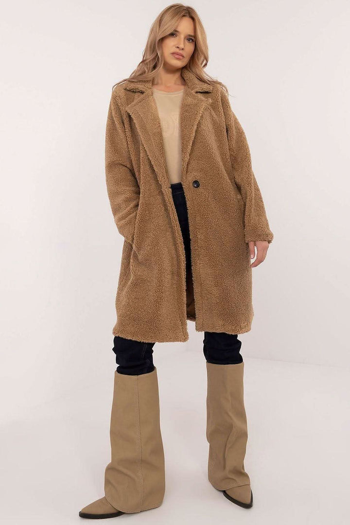 Stylish knee-length winter coat made from a polyester-viscose blend, perfect for everyday wear and work during colder months. Featuring a simple cut, long sleeves, button closure, slip pockets, and a comfortable lining, this coat offers warmth, comfort, and versatility in a classic design.