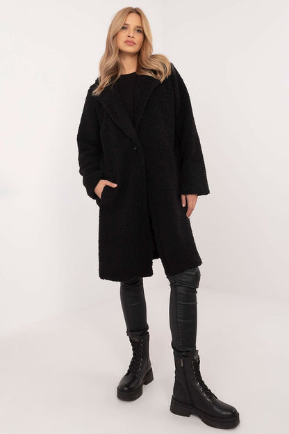 Stylish knee-length winter coat made from a polyester-viscose blend, perfect for everyday wear and work during colder months. Featuring a simple cut, long sleeves, button closure, slip pockets, and a comfortable lining, this coat offers warmth, comfort, and versatility in a classic design.