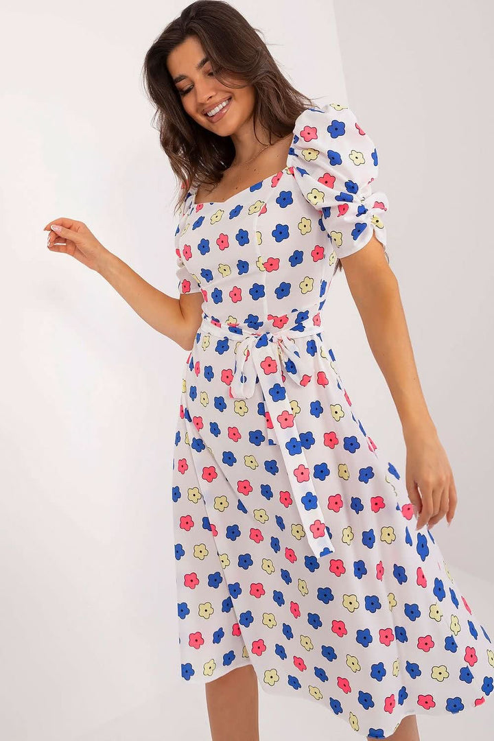 Charming summer youth dress with a flared cut, colorful print, heart-shaped neckline, buff sleeves, tie belt, and discreet back zipper