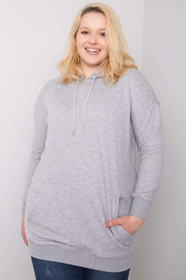 A grey melange plus-size cotton sweatshirt featuring a hood, extended cut, and convenient pockets. Perfect for comfort and style in everyday wear.






