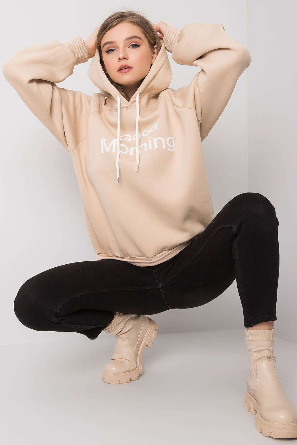 A cozy women's long sleeve sweatshirt with a hood, ideal for cool mornings and evenings. Offering both comfort and style, this hoodie is perfect for casual wear during transitional weather.






