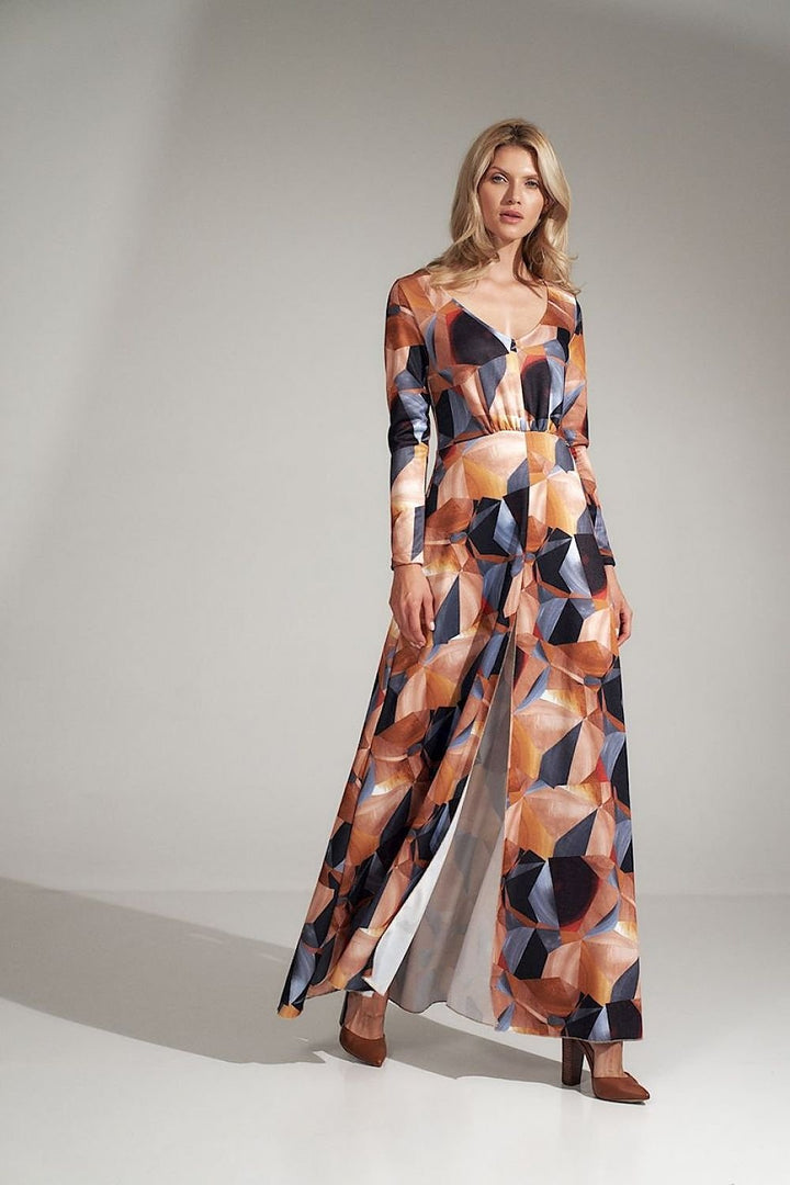 This stunning long dress features a flattering heart neckline and a bold geometric pattern, offering a mix of elegance and modern style. The waist is pleated and accented with a sewn-in elastic band, ensuring a comfortable and flattering fit. Long sleeves add sophistication, while the decorative front slit adds a touch of allure and movement. Made from elastic material, this dress provides flexibility and ease of wear, and it’s designed without any fastenings for added convenience. A perfect combination of 