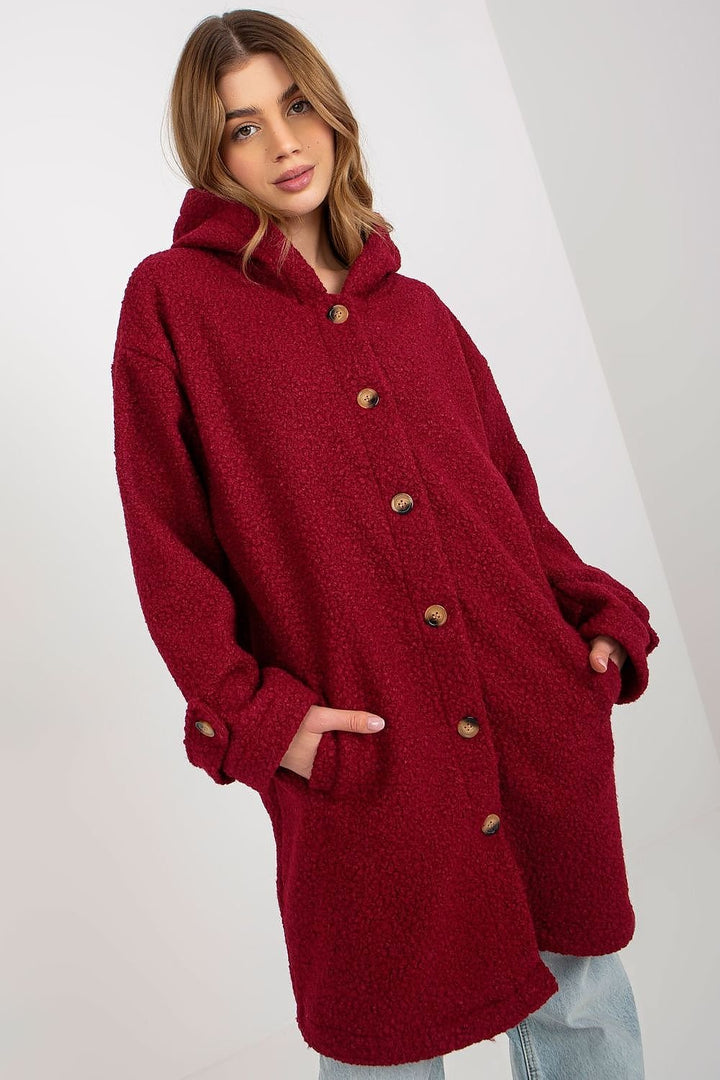 A cozy long-sleeve plush coat featuring a button closure, a hood for added warmth, and convenient slip pockets. The coat is unlined and uninsulated, offering a lightweight and comfortable fit.






