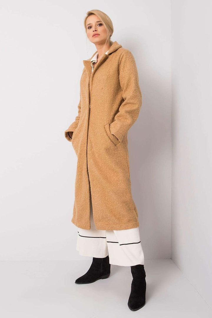 A sleek women's coat with long sleeves, featuring a press stud closure and side slip pockets. Unlined for a lightweight feel, this simple and modern coat is ideal for casual wear.






