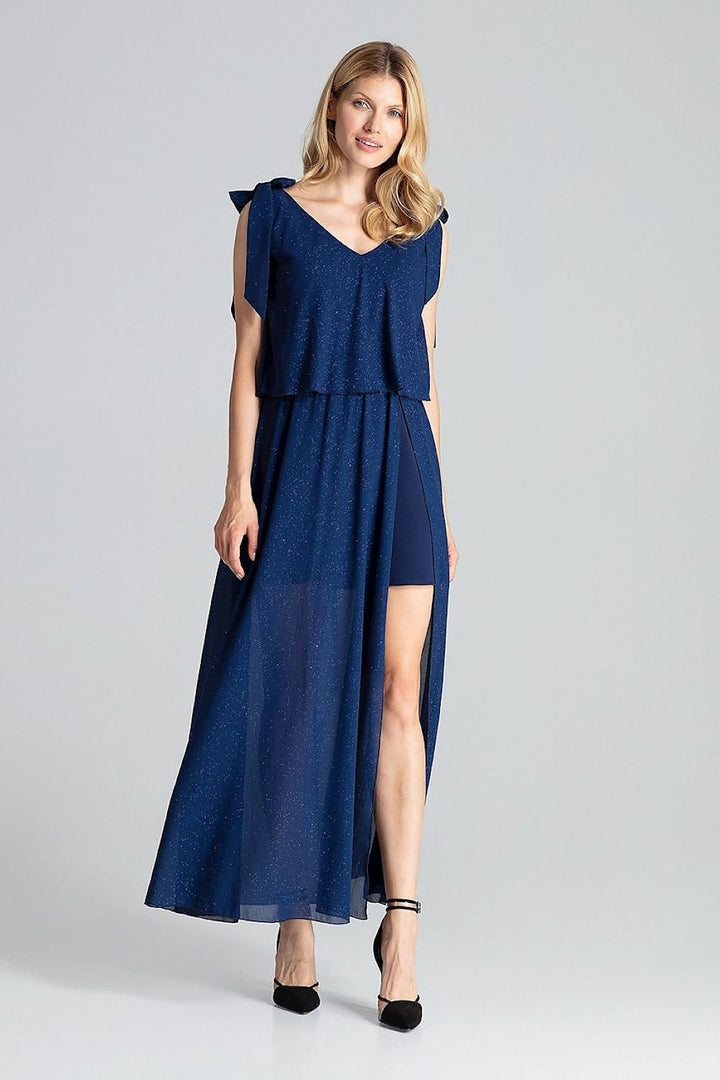 A sensual navy blue long sleeveless dress with a large deep neckline, tied at the shoulders, featuring airy fabric at the top, an elastic waistband, and a side slit from the waist to a slightly flared bottom before the knee.






