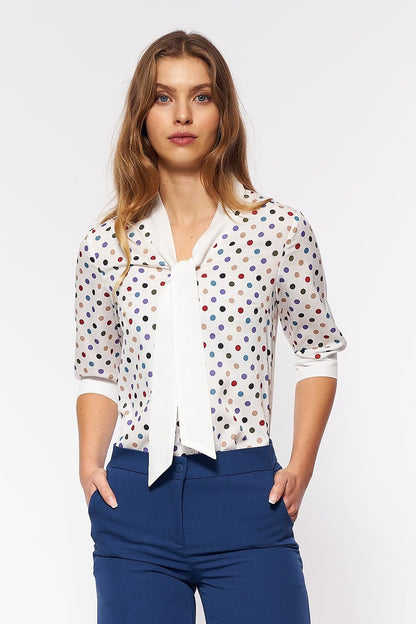 A delicate women's blouse featuring colorful polka dots, inspired by the playful 60s fashion. The print graces the front, while the back remains plain, offering a subtle and stylish addition to an office outfit. Perfect for adding a touch of girlish charm to your wardrobe.






