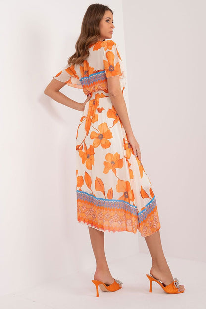 Summer dress with short sleeves in the form of frills. Dress with lining. Envelope neckline, belt fastened at the waist, pleated bottom. An ideal choice for many occasions.