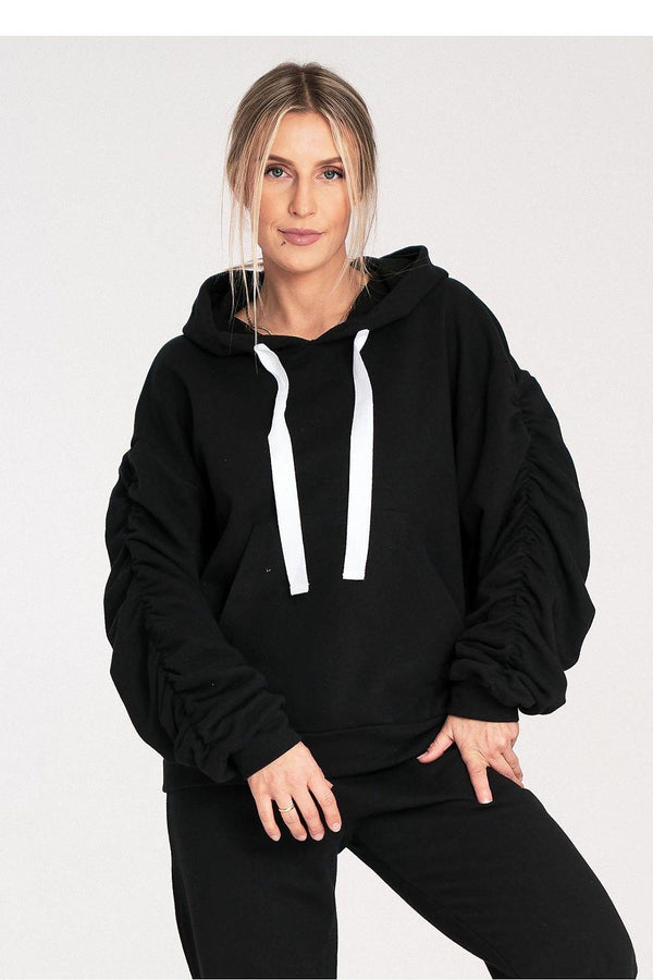 A thick cotton hoodie with ribbing, featuring a large front pocket and long, wide, decorative pleated sleeves. A stylish and comfortable choice for casual wear.






