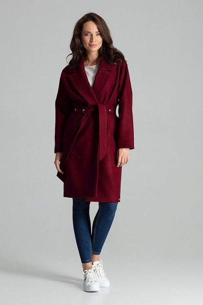 A refined red coat with wide lapels, designed to be worn unbuttoned and tied at the waist with a belt featuring metal eyelets. The coat includes side seam pockets and a matching color lining, offering a sleek and timeless look.






