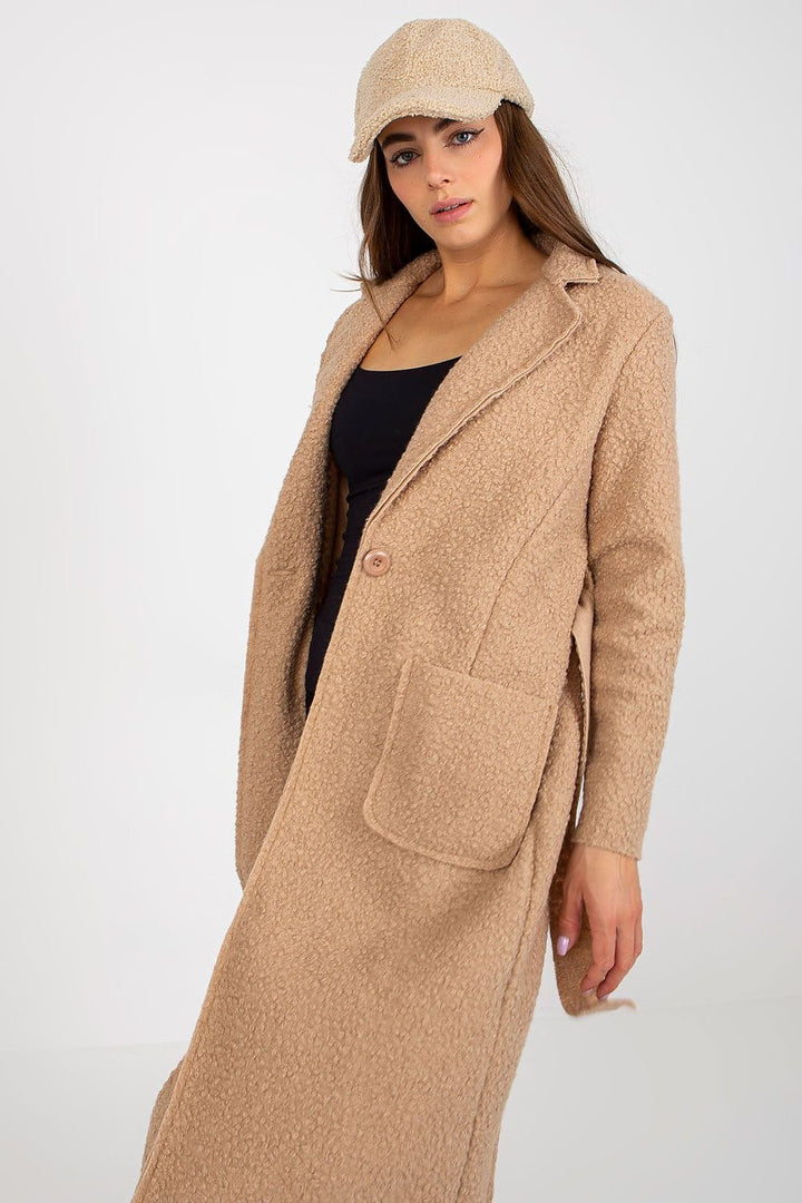 Women's coat with long sleeves and patch slip pockets. The coat is unlined, buttoned, with a tie belt.