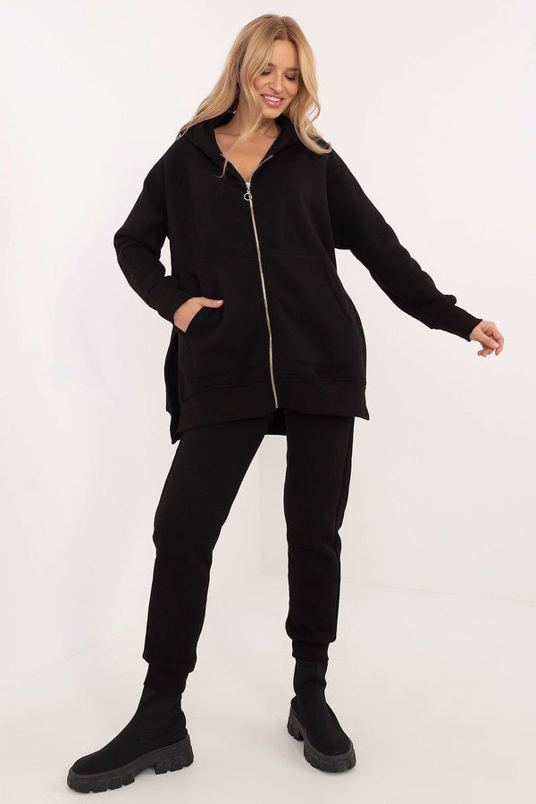This stylish tracksuit set is perfect for everyday wear, consisting of a zippered sweatshirt and matching pants. Made from a cotton-elastane blend, it offers comfort, softness, and freedom of movement. The sweatshirt features long sleeves, front patch pockets, and a hood for extra warmth, while the pants have a high-rise waist, ribbed cuffs, and side slip pockets. The elastic waistband ensures a comfortable and secure fit. Whether you're running errands or relaxing at home, this set combines practicality, c
