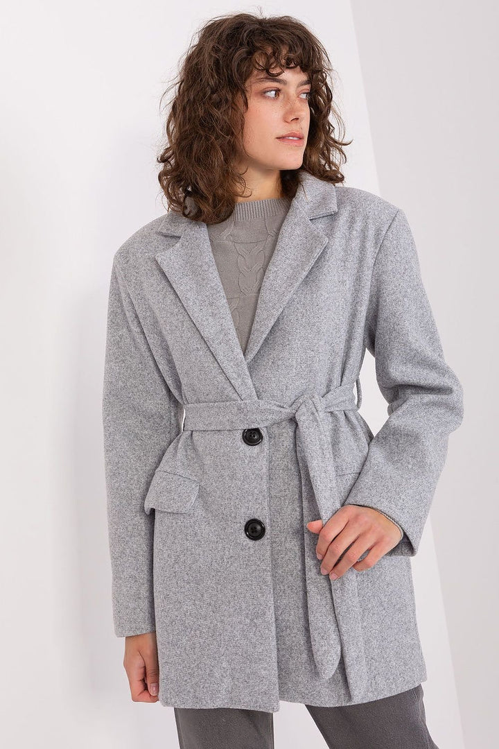 A smooth women's coat made of high-quality polyester, featuring a soft texture, long sleeves, and a classic cut. This versatile transitional coat includes a button closure, a standard length, and a lining for added comfort and durability. Perfect for both casual and formal occasions, it exudes timeless elegance and style.






