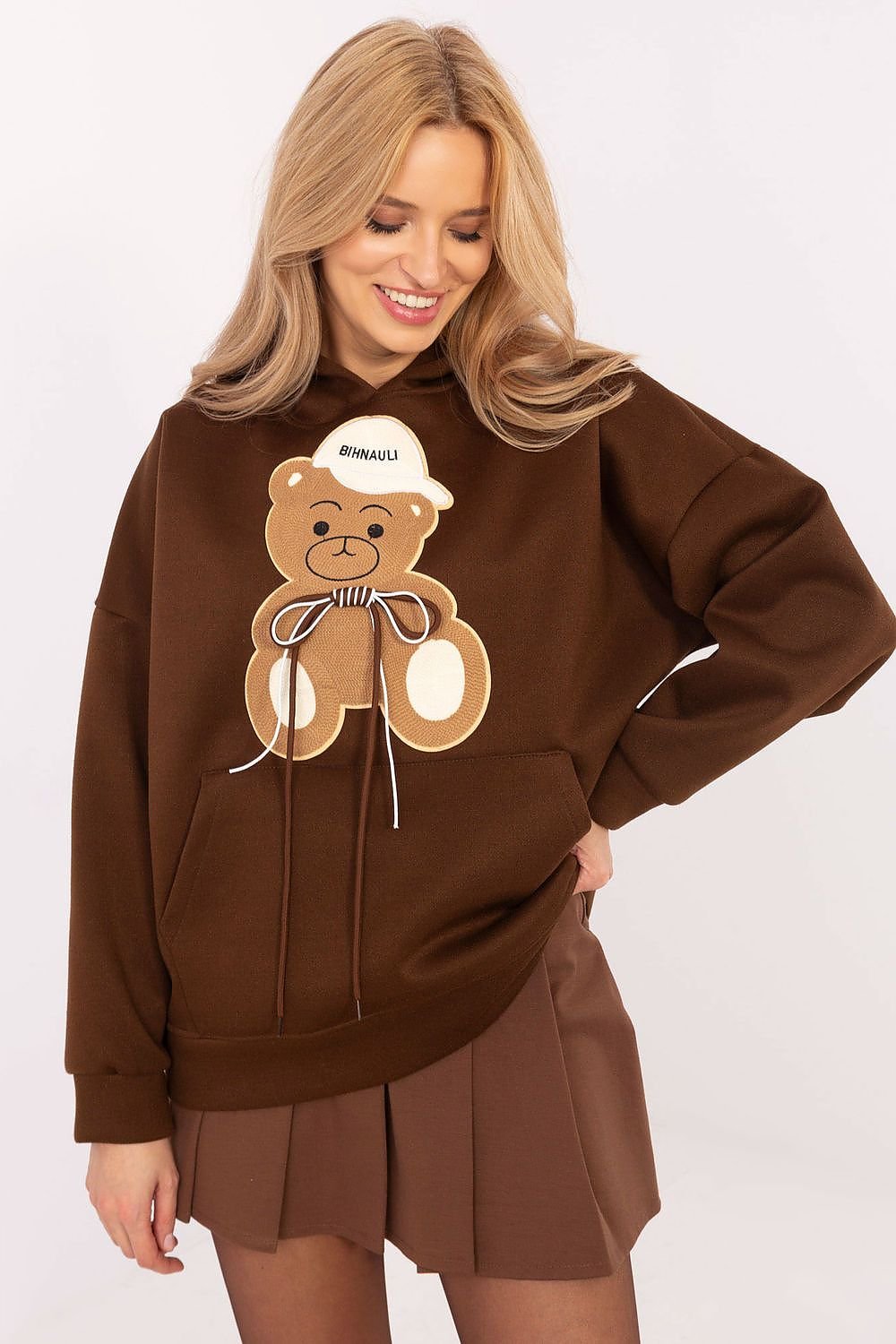 An oversized sweatshirt featuring a playful teddy bear graphic. the bear's cap, perfect for a cozy and stylish look.






