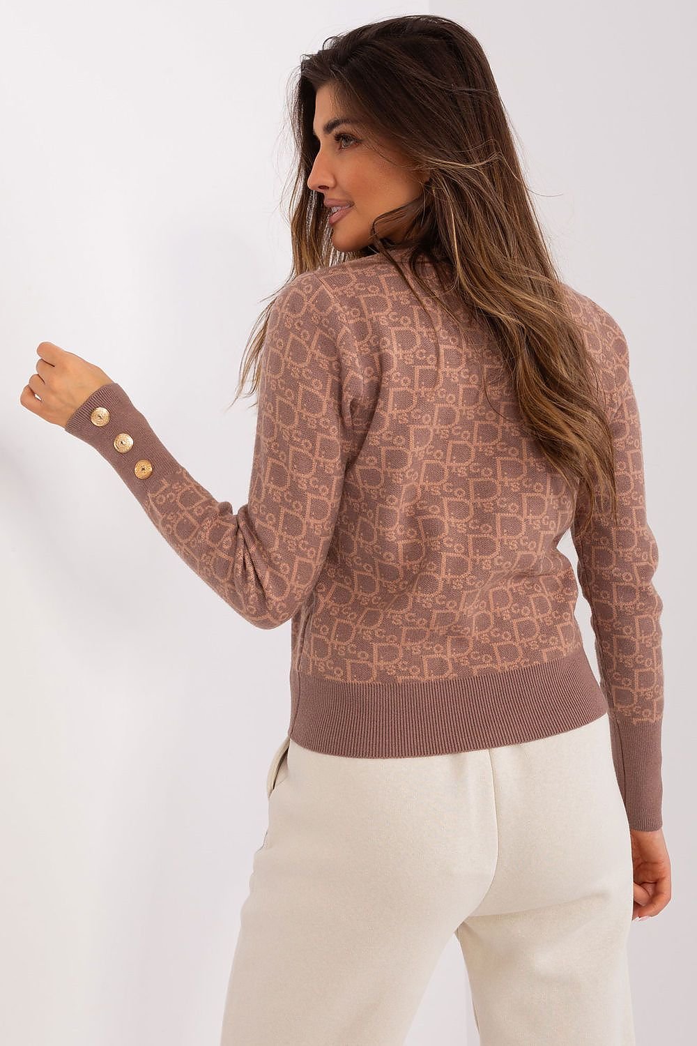 Timeless women's sweater with a round neckline, long sleeves, and decorative cuff buttons, featuring a unique print, perfect for casual everyday wear.






