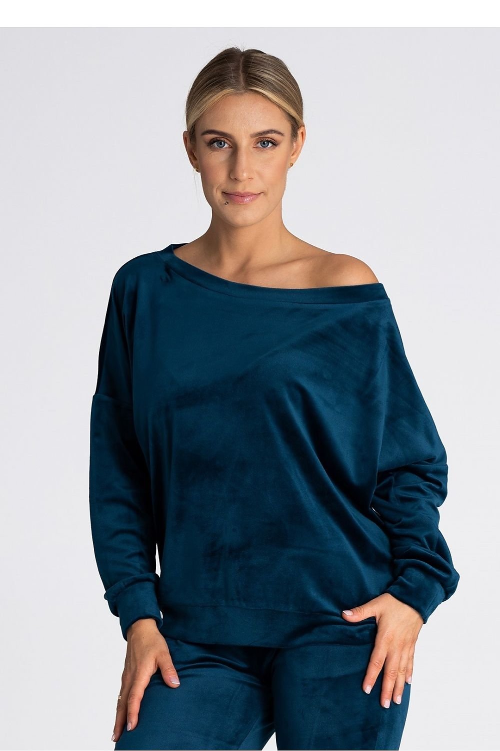 An oversized blouse featuring a boat neckline that can be worn off one or both shoulders. Finished with delicate cuffs for a stylish and elegant touch. Perfect for versatile, relaxed styling.






