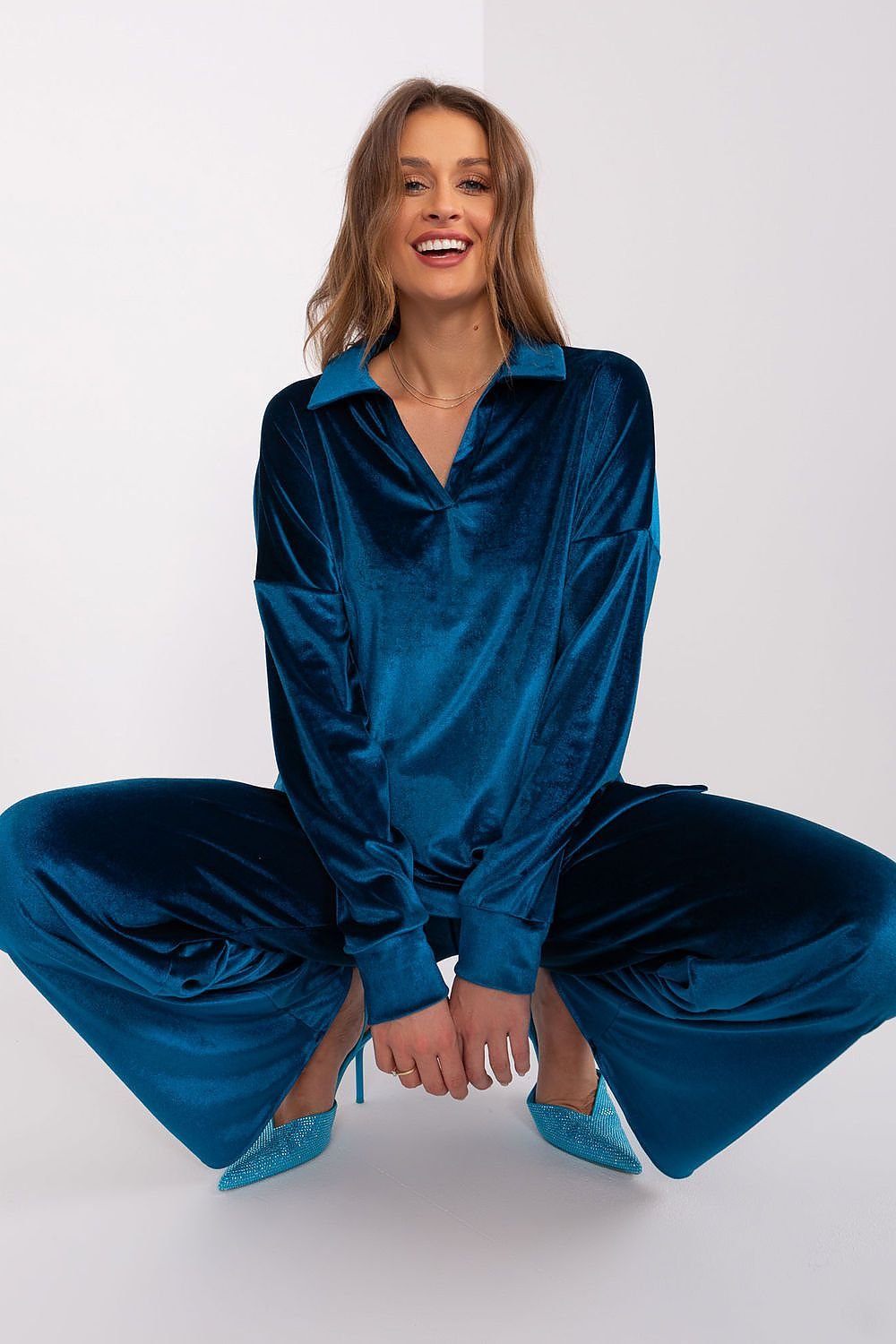 A women's velour set made from fine cotton, featuring a long-sleeve blouse with an elegant collar neckline. Paired with high-waisted, wide-leg pants with practical side slip pockets for comfort and style. Perfect for everyday wear, work, or relaxation.






