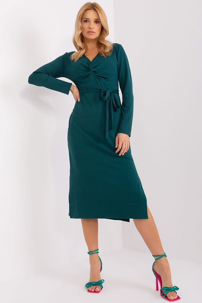 A stylish and versatile dress featuring an envelope neckline with decorative interlacing, long sleeves, and seductive slits at the bottom. Made from high-quality ribbed material, it includes a tie belt for a flattering silhouette, making it perfect for both special events and everyday wear.






