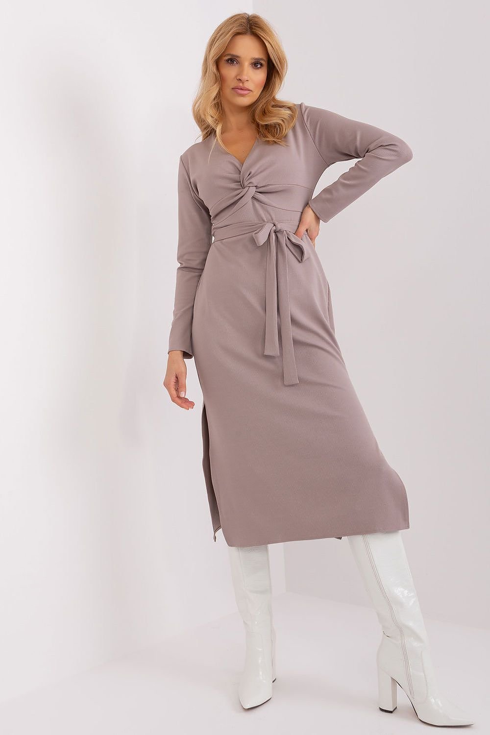 A stylish and versatile dress featuring an envelope neckline with decorative interlacing, long sleeves, and seductive slits at the bottom. Made from high-quality ribbed material, it includes a tie belt for a flattering silhouette, making it perfect for both special events and everyday wear.






