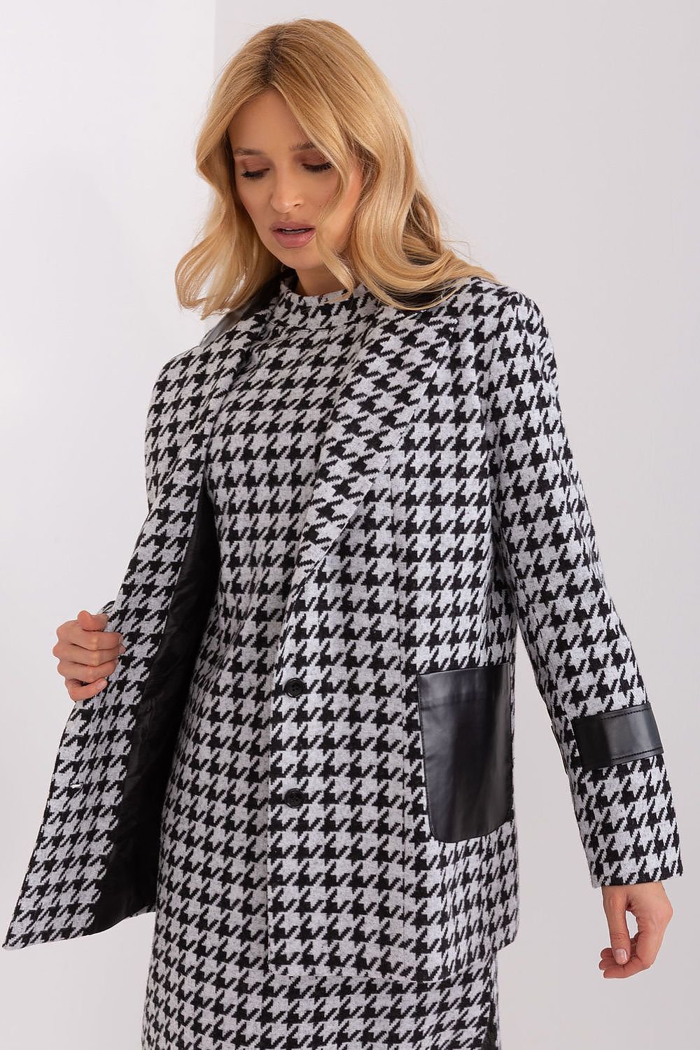 A stylish women's jacket featuring long sleeves, a lined collar, and button closure. Made from peplite fabric with eco-leather trim, it includes a lining for added comfort and slip pockets for practicality, offering a chic and modern look.