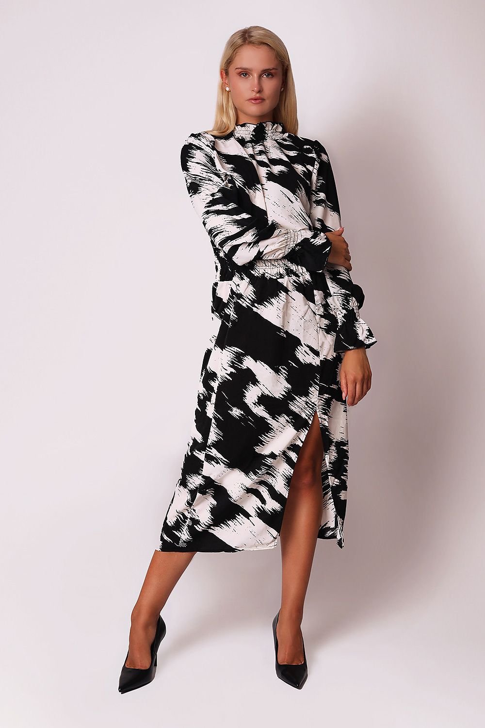 A sophisticated black and white printed midi dress featuring a ruffled collar, long sleeves with ruffled cuffs, and a deep ruffled waist with a side slit. Perfect for adding elegance and style to any occasion.






