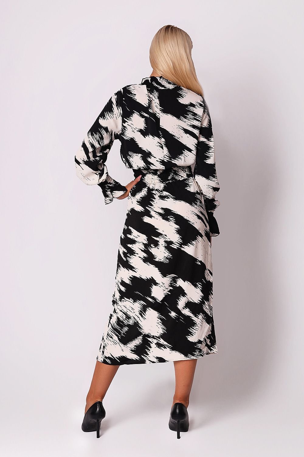 A sophisticated black and white printed midi dress featuring a ruffled collar, long sleeves with ruffled cuffs, and a deep ruffled waist with a side slit. Perfect for adding elegance and style to any occasion.






