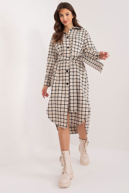 A stylish plaid midi shirt dress with an asymmetrical cut, featuring a tie belt, long sleeves, and a classic collar. Designed for comfort with soft cotton fabric, it’s perfect for work and casual occasions.






