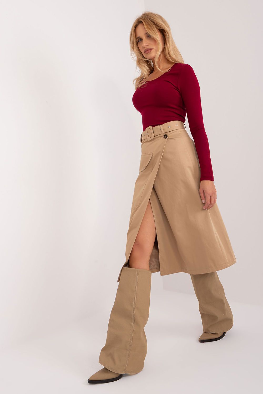 A midi skirt featuring an envelope front, buckled belt, button closure, patch pocket, and lining. Stylish and versatile for casual and formal occasions.

