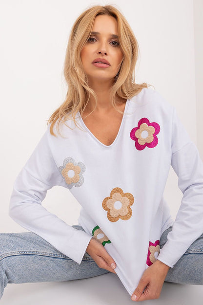 Charming floral blouse made from high-quality cotton, featuring a heart neckline, long sleeves, and a fresh, stylish design perfect for casual occasions.