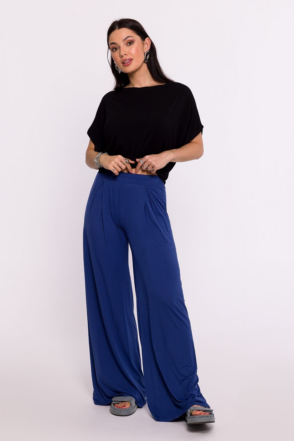 Women's pants made from high-quality viscose knit fabric, offering softness and comfort. Featuring an elastic waistband, modeling pleats for a flattering silhouette, and wide legs for freedom of movement. Designed and made in Poland, these pants combine elegance, functionality, and unique design. Perfect for various occasions.






