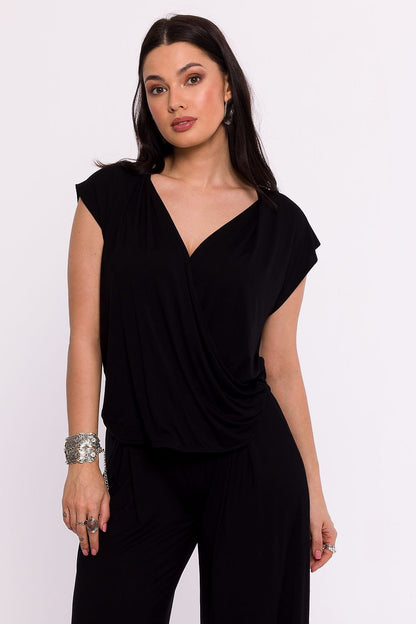  A high-quality viscose knit blouse with an envelope cut and draping for a light, elegant look. Features a deep neckline, short batwing sleeves, and a flattering fit that enhances the figure. Designed and manufactured in Poland for superior craftsmanship. Perfect for a variety of occasions.