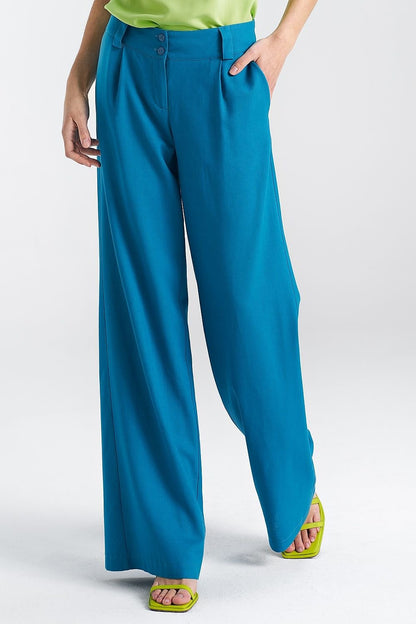 Crafted for women who prioritize both comfort and elegance, these relaxed fit pants are made from a premium mix of viscose, linen, and cotton, offering a lightweight, soft, and breathable feel. The mid-rise cut provides a flattering fit for a variety of body shapes, while the wide belt loops give the option to personalize your look. A decorative tab at the front adds a subtle, stylish twist to the pants, enhancing their casual yet chic appeal. The wide-cut legs create a flowing, modern silhouette, making a 