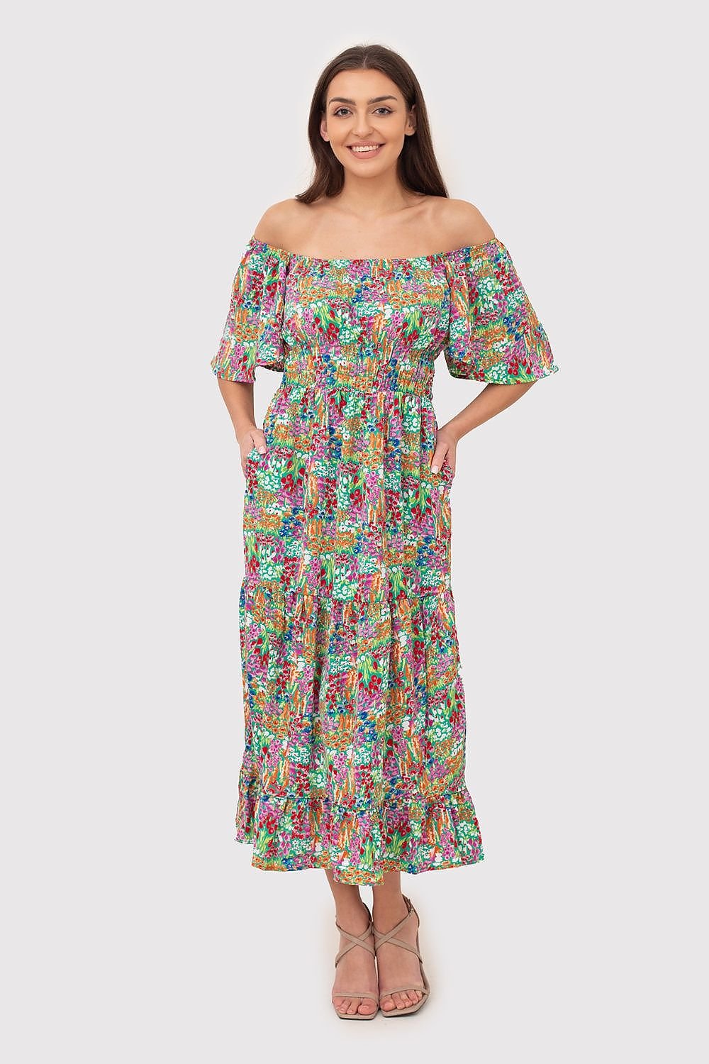 Summer-ready Bardot style midi dress with a flattering low-cut bodice, ruffled waist, and a ruffled hem. Featuring a vibrant print, this dress offers a chic and breezy look for warm weather.