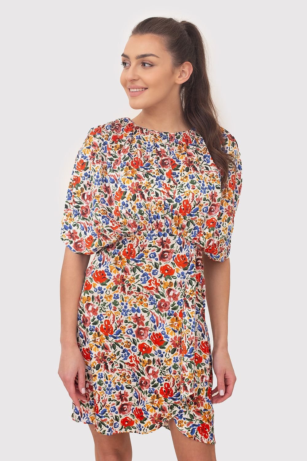 A vibrant summer mini dress featuring colorful flowers on flowing fabric, with decorative creases and wide sleeves. The elastic waistband ensures a comfortable and flattering fit, making it perfect for warm-weather outings.






