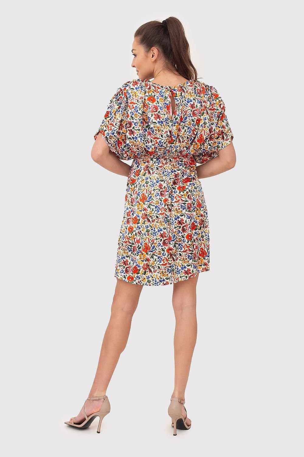 A vibrant summer mini dress featuring colorful flowers on flowing fabric, with decorative creases and wide sleeves. The elastic waistband ensures a comfortable and flattering fit, making it perfect for warm-weather outings.






