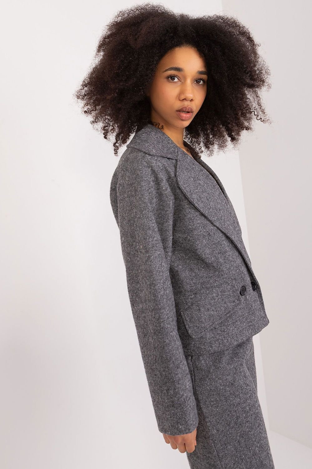 An elegant women's jacket with a double-breasted design, classic lapels, and long sleeves, ideal for formal and business settings. Made primarily of cotton for comfort and featuring a button closure, it’s perfect for colder days in autumn, winter, or spring. The lined interior enhances both comfort and aesthetics, making it a versatile and sophisticated addition to any wardrobe."