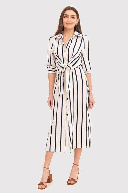 A versatile cream midi dress featuring navy blue stripes, 3/4 cuffed sleeves, a classic shirt collar, button-front closure, and a tie belt at the waist. Perfect for effortless style on any occasion.






