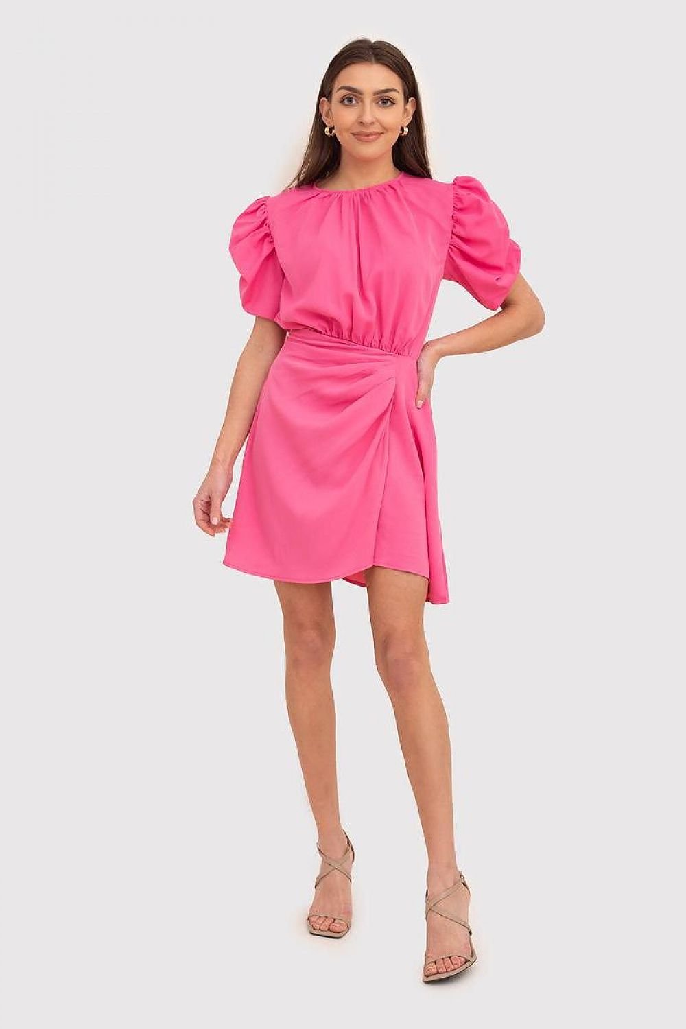 A beautiful pink mini dress featuring short bouffant sleeves, a round neckline, and pleated sides at the hem, fastened with a covered zipper for a chic look.






