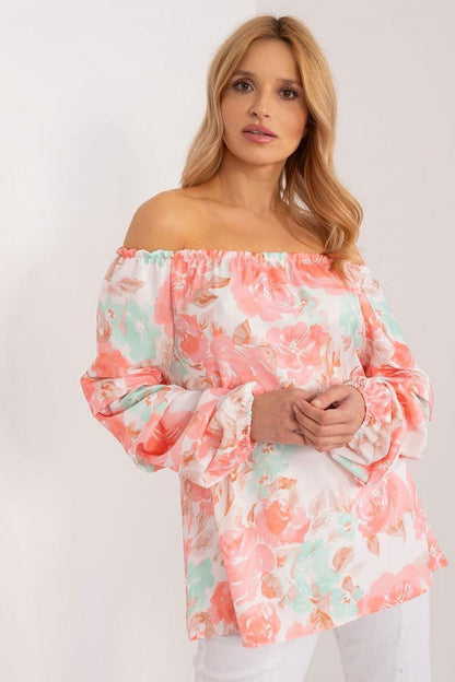 Colorful floral blouse with long buff sleeves, Spanish-style neckline, and elegant creases, perfect for a fresh and stylish summer look.