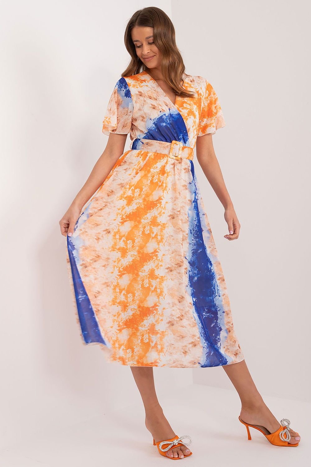 This dress embodies the perfect balance of everyday elegance, offering both comfort and style. The vibrant print adds a fun and energetic touch, making it suitable for any occasion. Its flared cut is flattering and feminine, ideal for both social gatherings and work. Crafted from easy-care polyester, it maintains its pristine look with minimal effort. The midi length offers versatility, while the short sleeves and heart neckline with an envelope cut enhance the dress's subtle feminine charm.